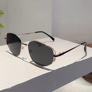 Detail of rose gold geometric metal frame and dark lenses on stylish sunglasses