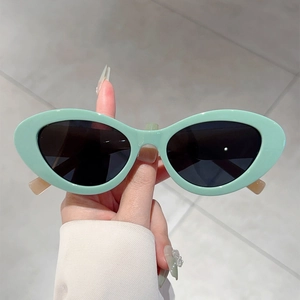 Retro cat-eye sunglasses with trendy mint green frames and dark lenses for women