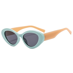 Cat eye sunglasses in mint green frame with orange temples and dark grey lenses