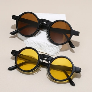 Detail of round steampunk sunglasses with matte black frames and color tinted lenses
