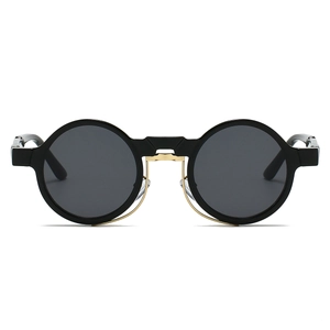 Close-up of vintage round steampunk sunglasses with black frames and gold metal accents