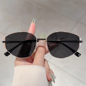 Chic minimalist oval sunglasses with golden metal frame and black lenses for daily sun protection