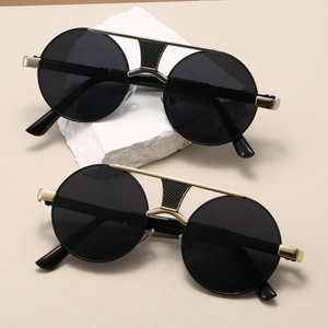 Close-up of retro double-bridge round sunglasses with gold and silver metal frames