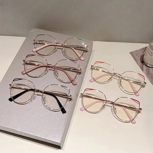 Chic cat-eye metal frame glasses in five colors displayed on a grey tray with soft light