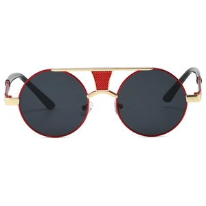 Macro view of retro round sunglasses featuring red accents and golden metal double bridge