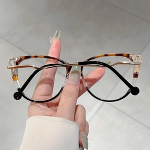 Cat-eye blue light glasses with tortoise-shell upper frame and golden metal temples