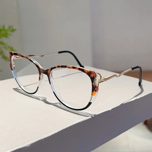 Detailed side view of cat-eye frames with tortoiseshell pattern and gold wave temples