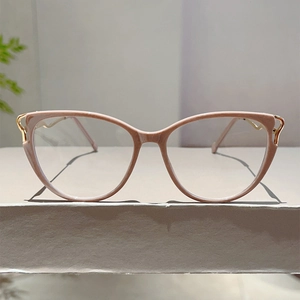 Detailed view of pink cat-eye glasses frame with elegant golden metal temple hinges