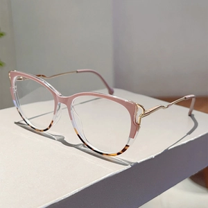 Close-up of cat-eye frames with pink top detail and wavy gold metal temples