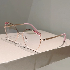 Detail of rose gold cat-eye glasses frame with pink trim and sleek metallic finish