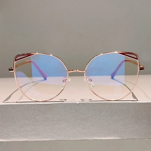 Detail of cat-eye glasses with rose gold hollow frame and anti-blue light lenses
