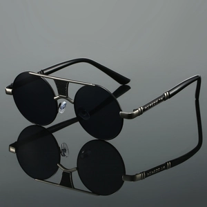 Detail of retro round sunglasses showing double metal bridge and textured grid design