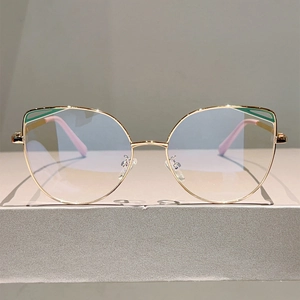 Cat-eye metal glasses frame with green enamel accents and blue light blocking lenses