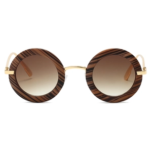 Detail of retro round sunglasses with wood grain texture frames and gold metal temples