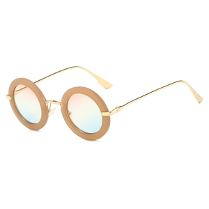 Detail of retro round sunglasses featuring thick tan frames and gradient lenses