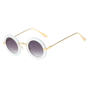 Detailed close-up of retro round sunglasses with purple gradient lenses and gold temples