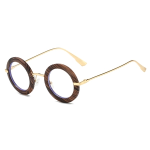 Macro detail of retro round sunglasses with wood grain texture and gold metal arms