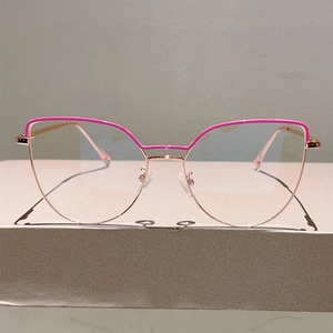 Detail of rose gold cat-eye glasses frame with pink trim and adjustable nose pads