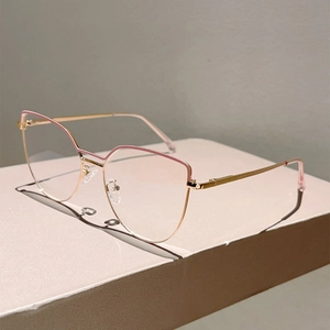Detailed side view of cat-eye frames with pink accents and golden metal temples