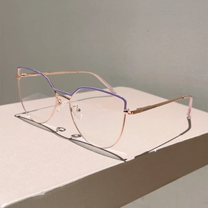 Detailed close-up of retro cat-eye metal glasses with rose gold and purple frame details