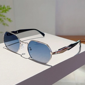 Detail of octagonal silver metal sunglasses with gradient blue-purple lenses on display