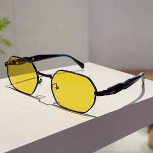 Detail showing vintage octagonal sunglasses with yellow lenses and a sleek black metal frame