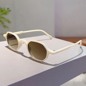 Close-up of retro cream white round frames with brown lenses on a purple display stand