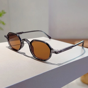 Detail of vintage smoke gray octagonal sunglasses with brown lenses on display pedestal