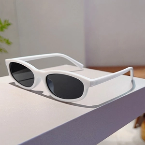 Detailed close-up of white oval small frame sunglasses with dark lenses on display