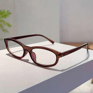 Macro detail of oval dark brown transparent sunglasses frame with lightweight resin texture