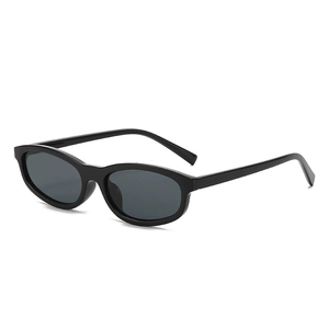Fashionable oval small frame black sunglasses with sleek dark lenses on white background