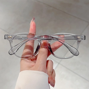 Detail showing high-quality metal hinges and transparent grey frame of these large glasses
