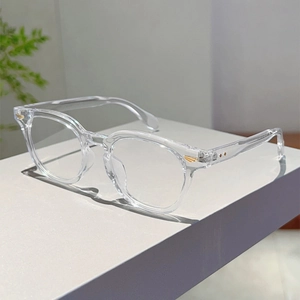 Detail view of transparent round glasses frame with elegant gold V-shaped metal accents