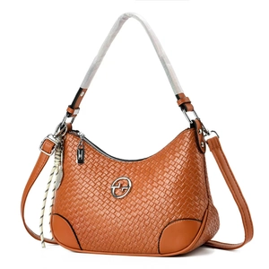 Brown woven texture handbag with silver round logo and adjustable shoulder strap