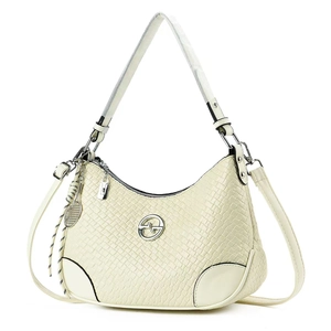 Close-up of beige woven texture crossbody bag with metal logo and mesh charm detail