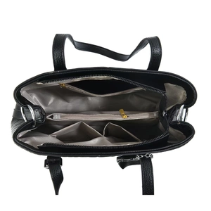 Interior view of black leather handbag showing multiple compartments and herringbone lining