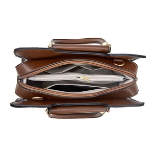 Detail view of large capacity bag interior with three compartments and golden zippers