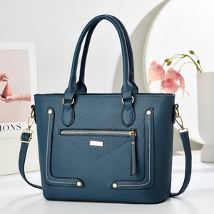 Navy blue lychee pattern leather handbag with gold hardware and rivet details
