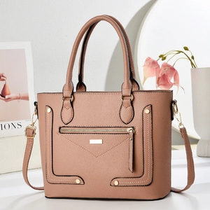 Detail of lychee pattern leather handbag with gold zippers and detachable strap