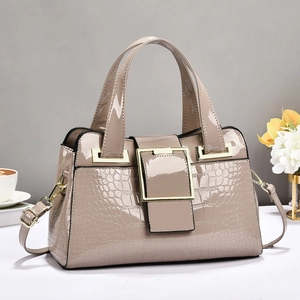 Elegant beige patent leather handbag with crocodile pattern and golden buckle