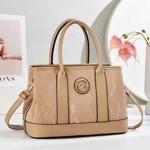 Classic beige marble patterned tote bag with golden metal logo and adjustable shoulder strap