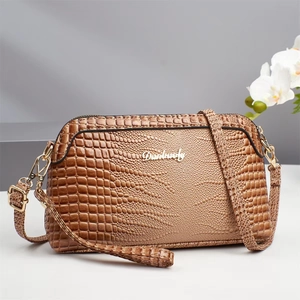 Brown crocodile embossed leather crossbody bag for women with metal logo and strap