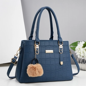 Deep blue handbag with crocodile pattern texture and golden metallic accessories