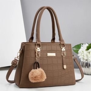 Classic brown crocodile embossed tote bag with gold metal plaque and furry pompom charm