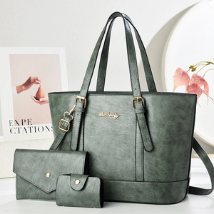 Three-piece dark green tote bag set with textured leather and gold hardware accents