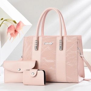 Three-piece pale pink tote bag set with matching clutch and card holder in textured leather