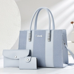 Stylish 3-piece light blue tote bag set with contrast striped fabric and metal logo detail
