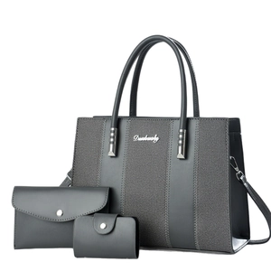 Deep grey three-piece handbag set including tote, clutch, and card holder with fabric detail