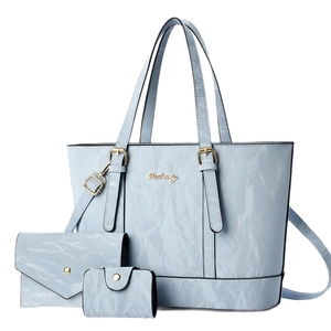 Three-piece light blue handbag set with tote, wallet and pouch in crinkle texture