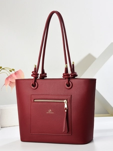 Deep burgundy textured leather tote bag with unique knotted rope handles and gold zipper detail